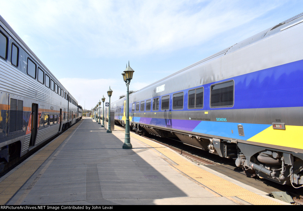 Two Amtrak San Joaquin Trains sitting opposite each other at BFD Station